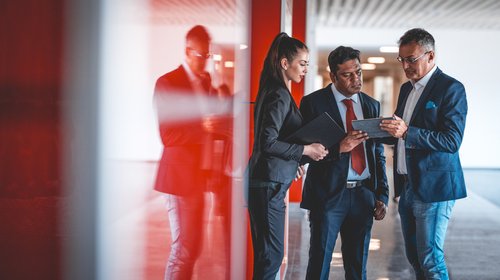 business people red background_iStock-697959256