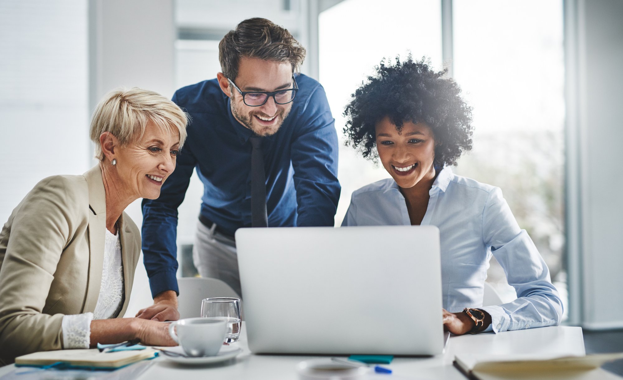 professionals working at computer_iStock-1766803516