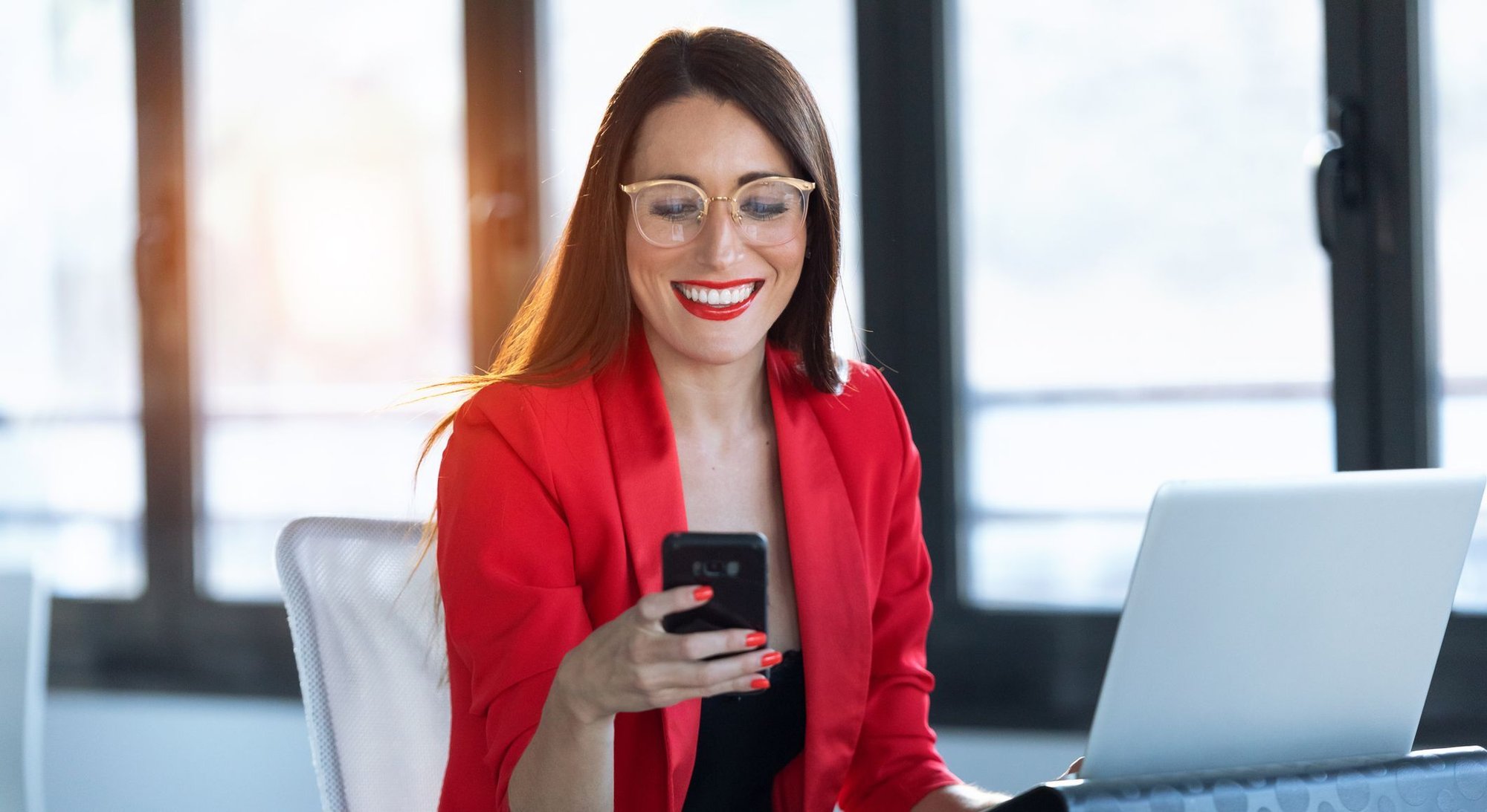 woman in red using technology_iStock-1181864446-modified-8ad63574-e875-4021-9645-b0da6d40b6ca